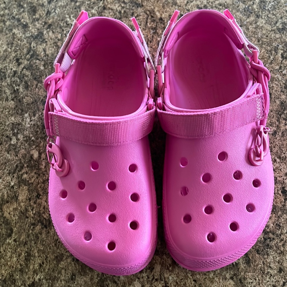 Post Malone electric pink crocs.